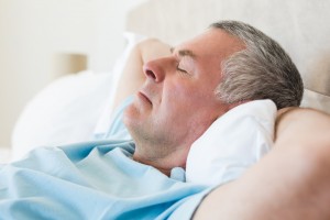 Senior man lying on bed